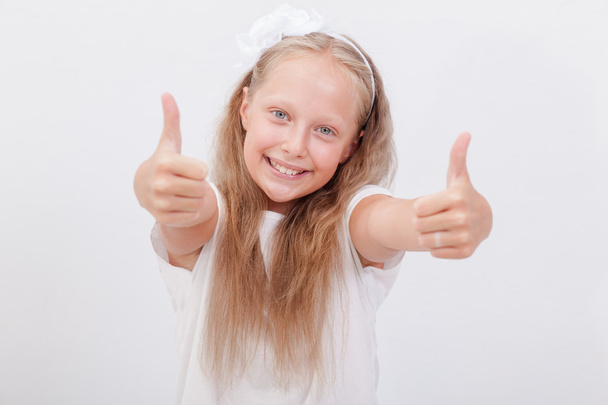 Portrait of a beautiful girl showing thumbs up on white - Fotografie, Obrázek