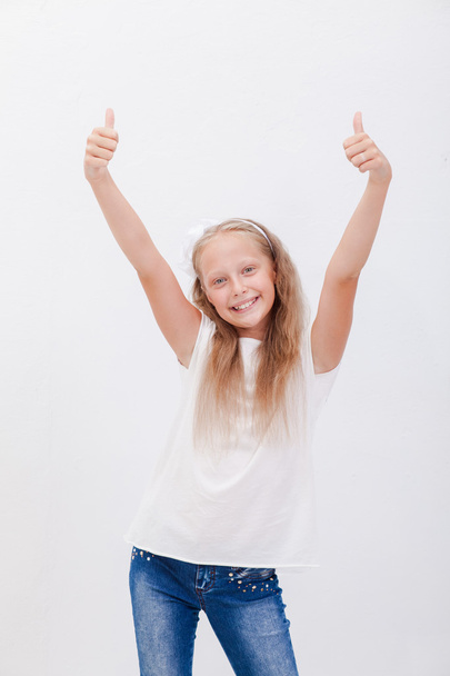 Portrait of a beautiful girl showing thumbs up on white - Foto, immagini