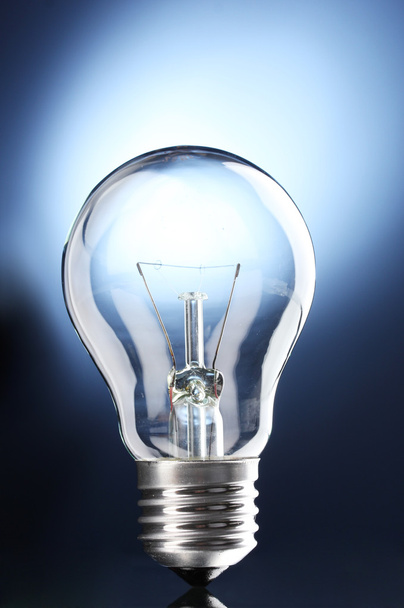 Light bulb on blue background - Foto, immagini