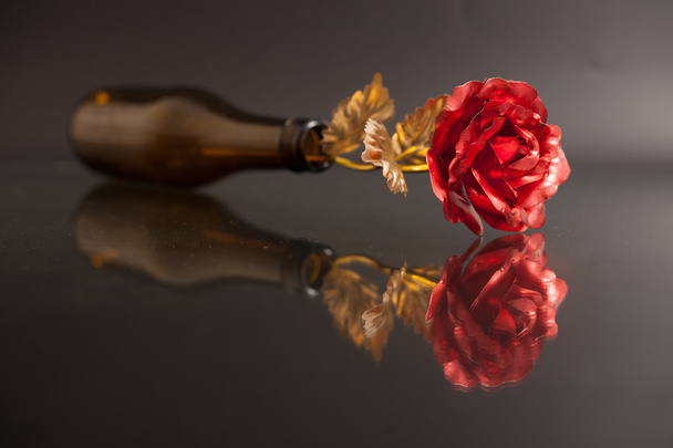 a bottle with one golden-rose - Photo, Image