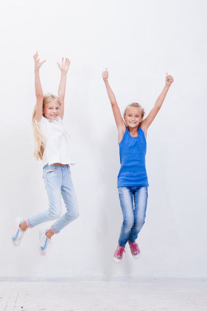 Group of happy young girls jumping  on white background - Foto, afbeelding