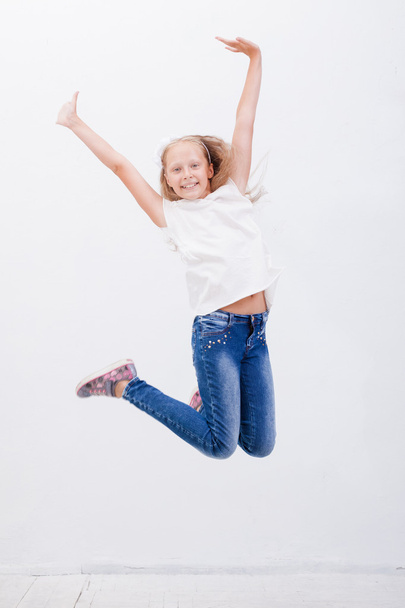  happy young girl jumping  on white background - Valokuva, kuva
