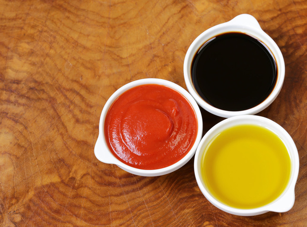 traditional Italian sauces - balsamic vinegar, tomato sauce and olive oil - Photo, Image