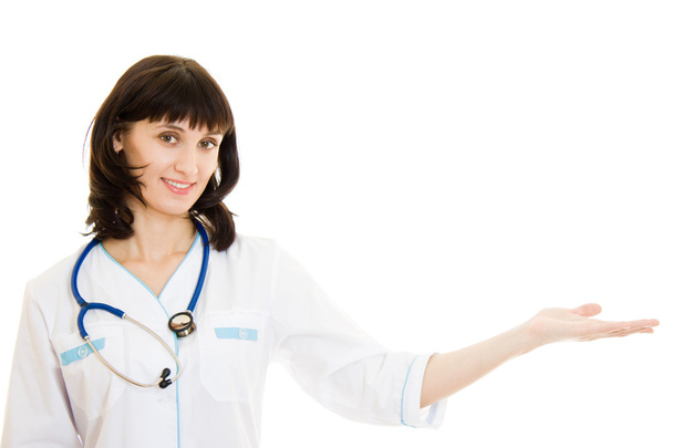 Woman doctor with arm outstretched on a white background. - Φωτογραφία, εικόνα