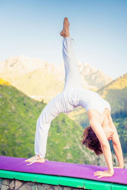 Asian woman doing yoga at mountain - Fotó, kép