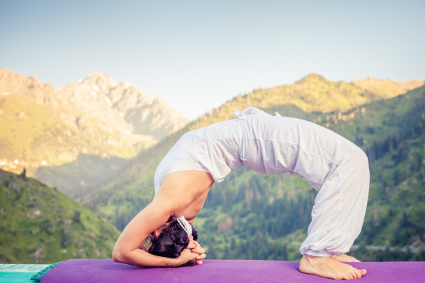 Asian woman doing yoga at mountain - Fotó, kép