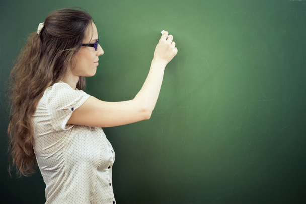 Teacher or student wrote on blackboard with chalk at classroom - 写真・画像