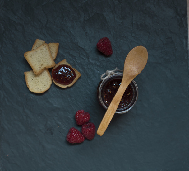  jam jar with raspberry jam and bread - Fotó, kép