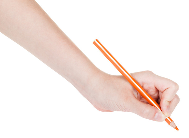 χέρι τραβάει φύλλα από πορτοκαλί μολύβι που απομονώνονται σε λευκό - Φωτογραφία, εικόνα