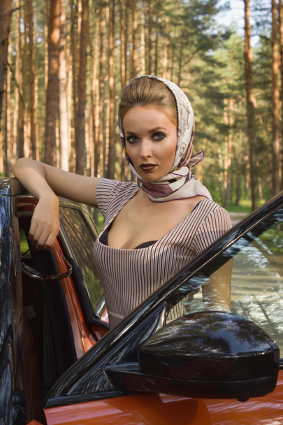 Fashion woman standing near vehicle with opened door - Zdjęcie, obraz