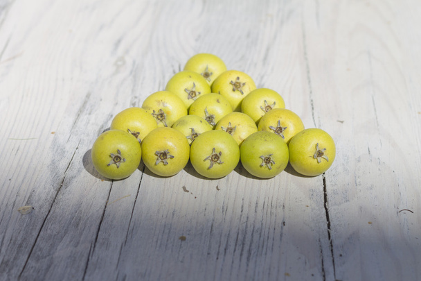 Green fruits on wooden background - Valokuva, kuva