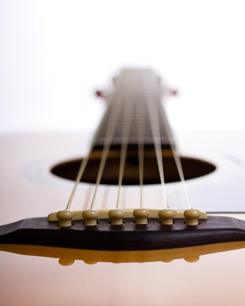 Bridge of acoustic guitar against light - Photo, Image