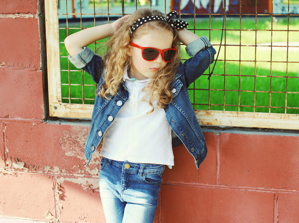 Fashion kid concept - stylish little girl child wearing a jeans  - Fotó, kép
