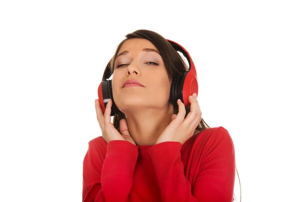 Woman with headphones listening music. - Φωτογραφία, εικόνα