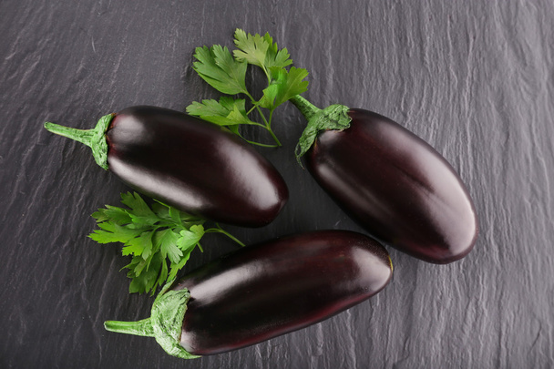 Fresh eggplant with parsley on wooden background - Foto, Bild