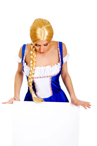 Woman wearing Bavarian dress holding empty banner. - Foto, Imagem