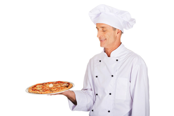 Chef baker with italian pizza - Foto, imagen