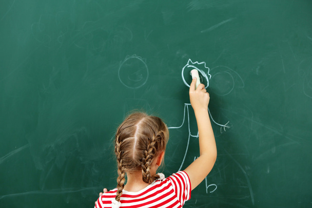 Girl drawing on blackboard, close-up - Фото, изображение