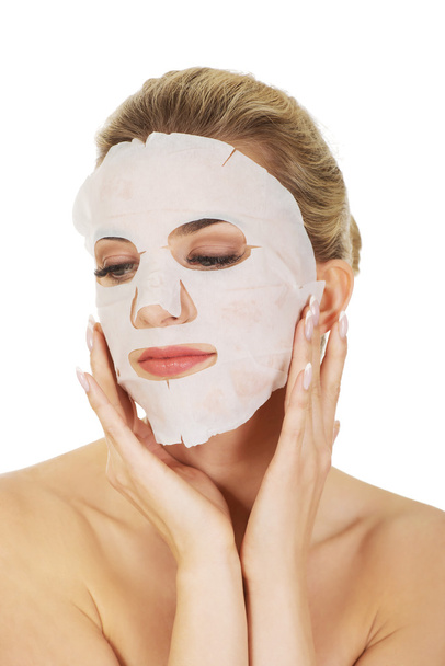Young happy woman with facial mask. - Foto, Bild