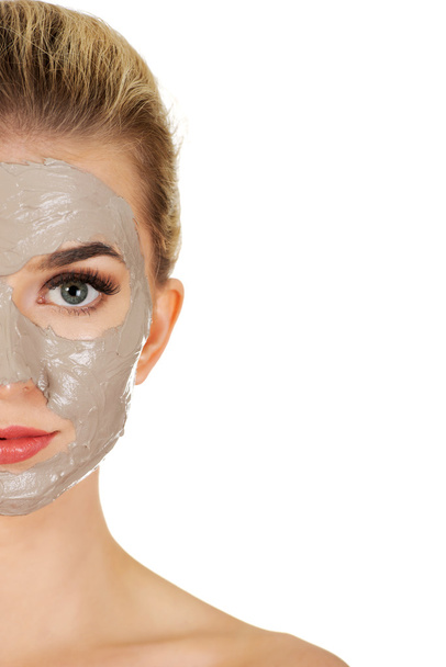 Half face of young woman with facial mask - Foto, imagen