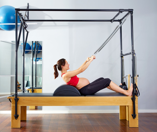 pregnant woman pilates reformer roll up exercise - Foto, imagen