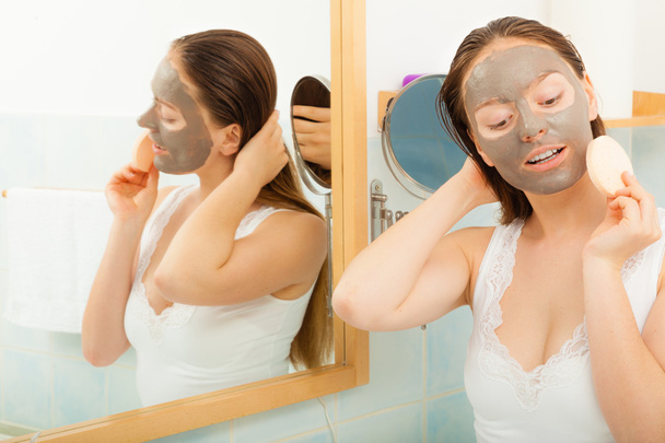 Woman face with mud facial mask - Фото, изображение