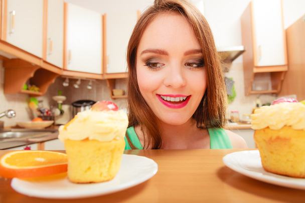 Woman looking at delicious sweet cake. Gluttony. - Valokuva, kuva