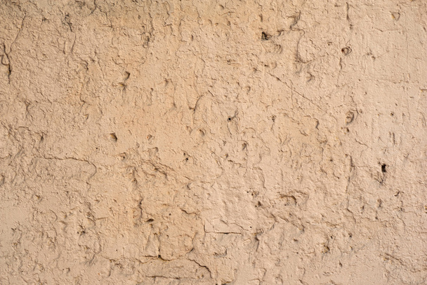 Texture of old wall covered with yellow stucco - Фото, изображение
