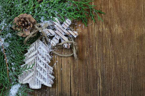 fir branches arborvitae with wooden Christmas decorations - Photo, image