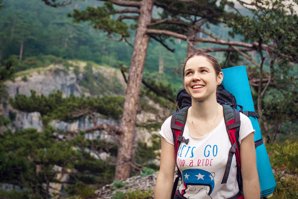 Caucasian hiker woman on trek in mountains with backpack living a healthy active lifestyle. Hiker girl on nature landscape hike in Crimea. - Photo, Image