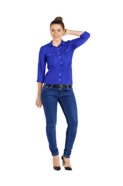 Portrait of a beautiful woman in blue jeans and blue shirt - Фото, зображення