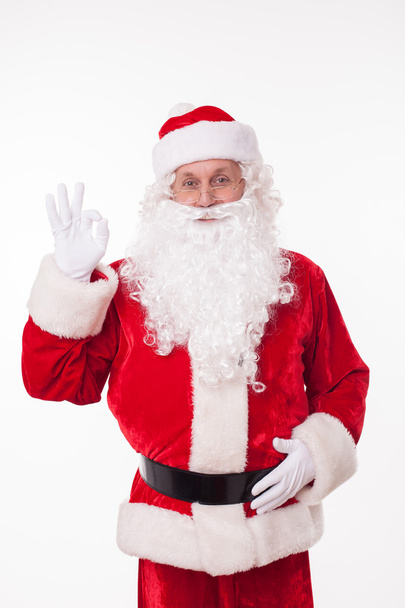 Gorgeous old Father Christmas is gesturing positively - Foto, imagen