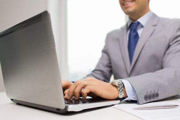 close up of businessman with laptop and papers - Photo, image