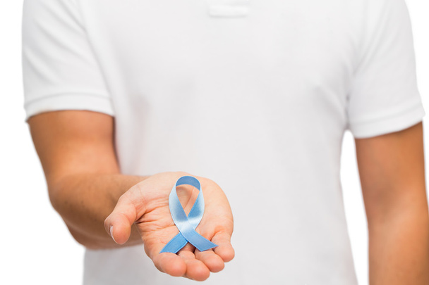 hand with blue prostate cancer awareness ribbon - Φωτογραφία, εικόνα
