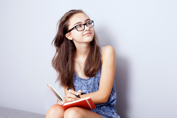 Teenage girl doing homework. - Фото, изображение