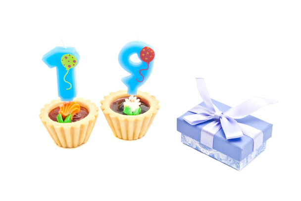 cakes with nineteen years birthday candles and gift on white - Фото, зображення