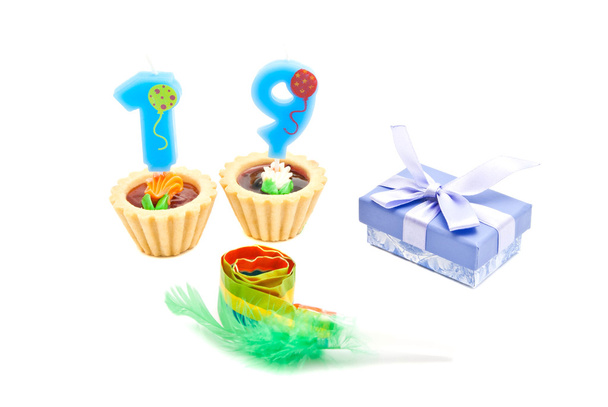 cakes with nineteen years birthday candles, whistle and gift on  - Фото, зображення