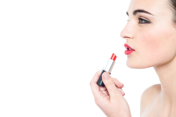 teen model applying red lipstick - Foto, Imagem