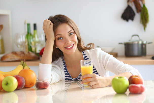 Portrait of a pretty woman holding glass with tasty juice - Photo, image