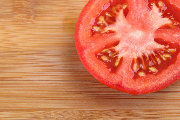 Top view of half tomato on wooden background. sliced tomato - Foto, Imagen