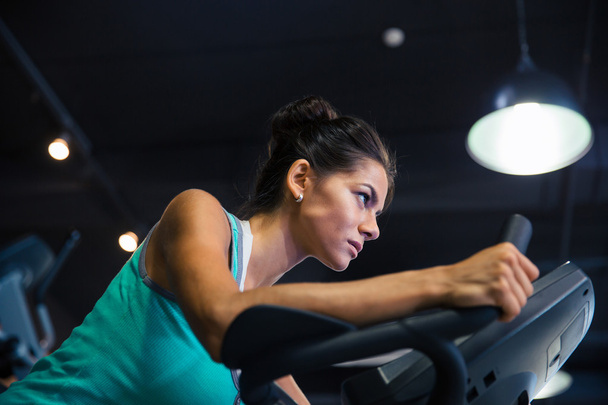 Woman workout on exercises machine - Foto, imagen
