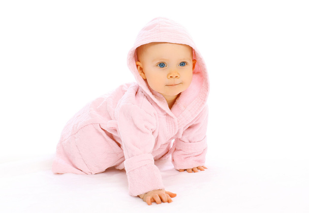 Portrait of cute little baby crawls in the pink bathrobe - Photo, Image