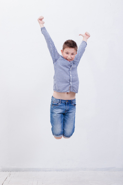happy young boy jumping  on white background - Фото, зображення