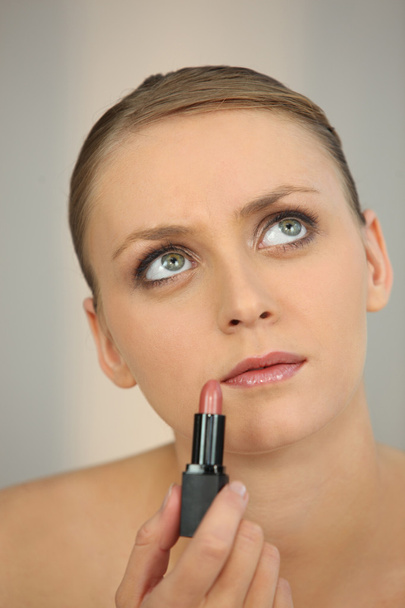 Woman applying pink lipstick - Zdjęcie, obraz