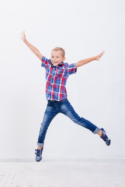 happy young boy jumping  on white background - Valokuva, kuva