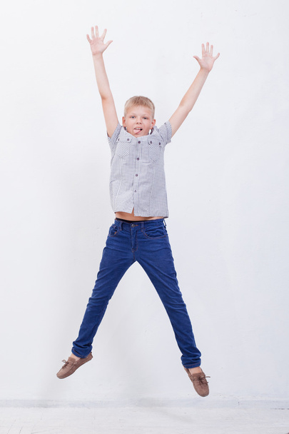 happy young boy jumping  on white background - Фото, зображення