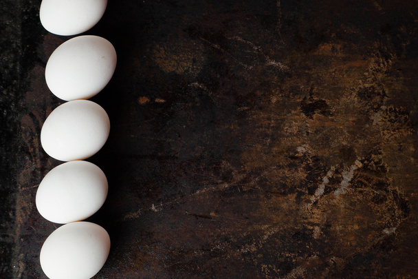 Eggs on dark background - Φωτογραφία, εικόνα