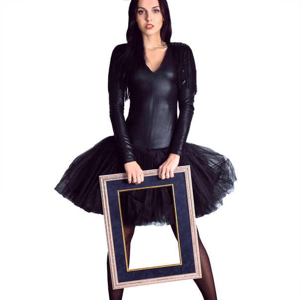 Woman wearing in black dress holding picture frame. Isolate - Zdjęcie, obraz