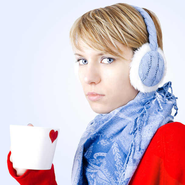 Blond girl holds cup of tea. Image has clipping path. - Fotografie, Obrázek