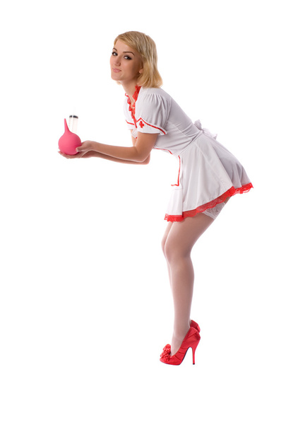 Sexy young nurse with enema and a syringe in his hand - Photo, Image